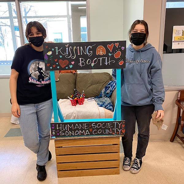 Healdsburg High School students Tatiana and Bianca with the decorated kissing booth