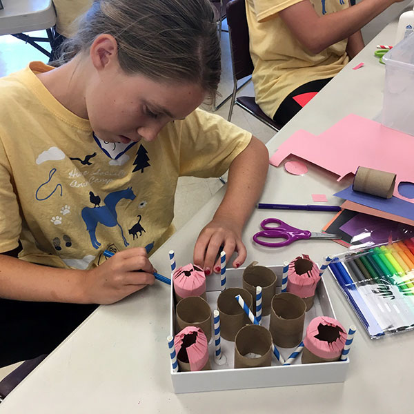Child making animal enrichment items in Animal Adventure Camp