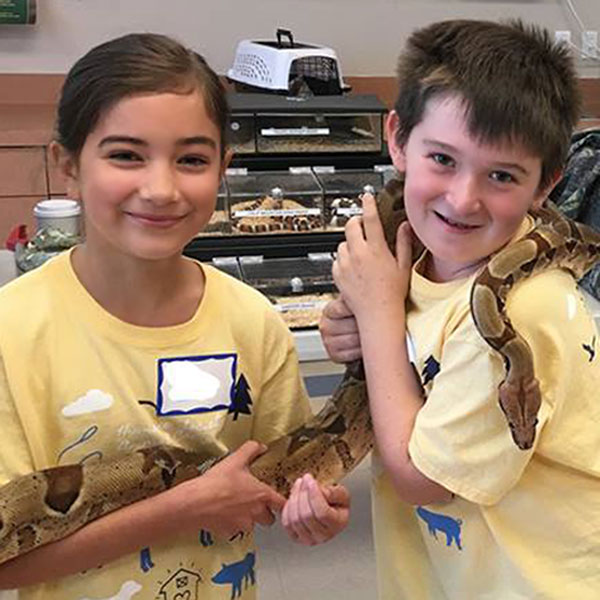 Kids holding a snake in Animal Adventure Youth Camp