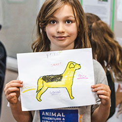 Girl holding up adoption poster