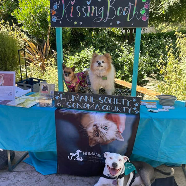 Bubbles the dog and the HSSC Kissing Booth at Breathless Winery