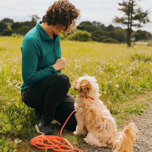 Woman with dog in field