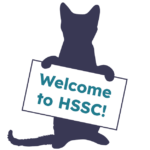 Cat holding 'Welcome to HSSC' sign